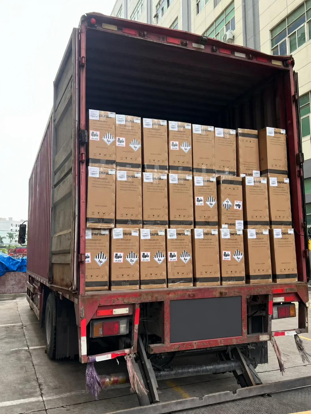 Privacy-edited view of cartons inside the rear of a delivery truck