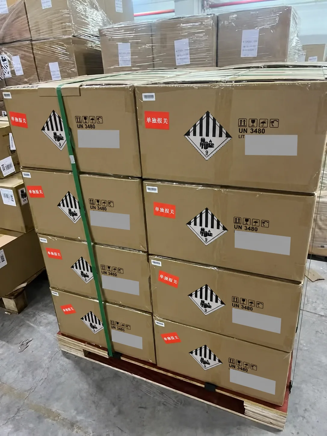 Privacy-edited view of strapped cartons on a pallet